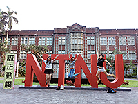 Classmate and I jumping high in front of the NTNU sculpture